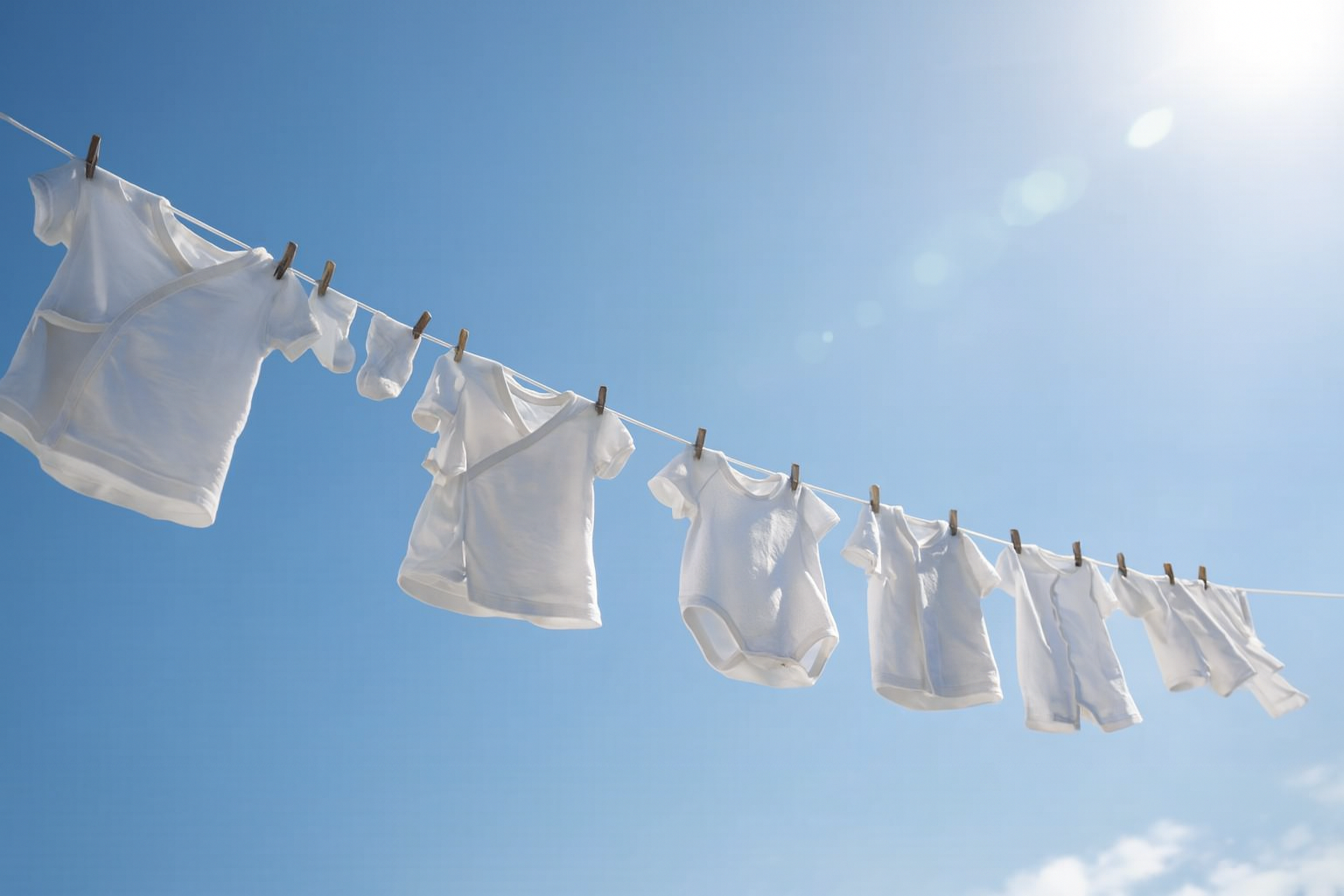 Baby clothes drying on a laundry rack