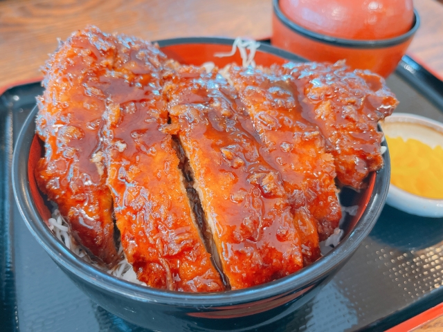 Aizu's famous sauce katsu-don with thick cutlets placed on rice and cabbage