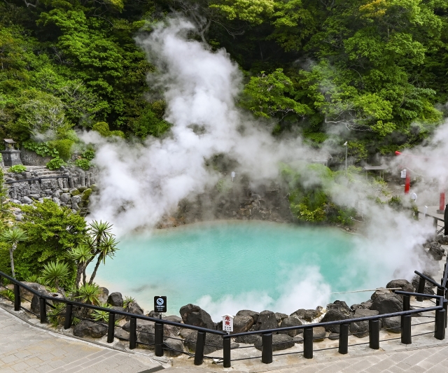 The spectacular view of Umi Jigoku with white steam rising from its beautiful cobalt blue hot spring source
