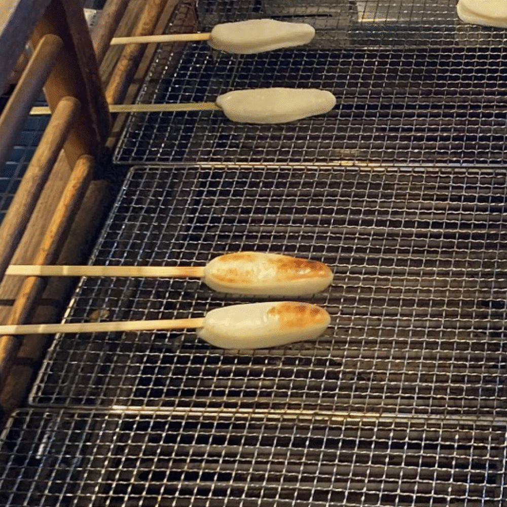 Scene of hand-grilling sasakama at the storefront of Matsushima Kamaboko Honpo