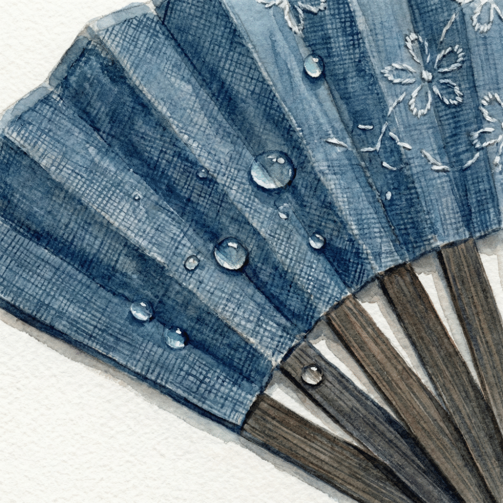 A linen fabric fan partially opened, showing soft texture and subtle water-resistance