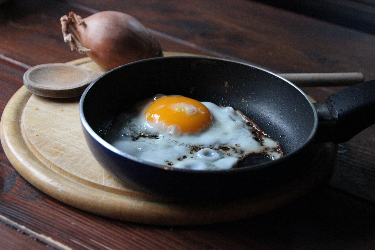 Compact Japanese frying pan being used on a small stovetop for single-serving breakfast — showing practical size for one or two people
