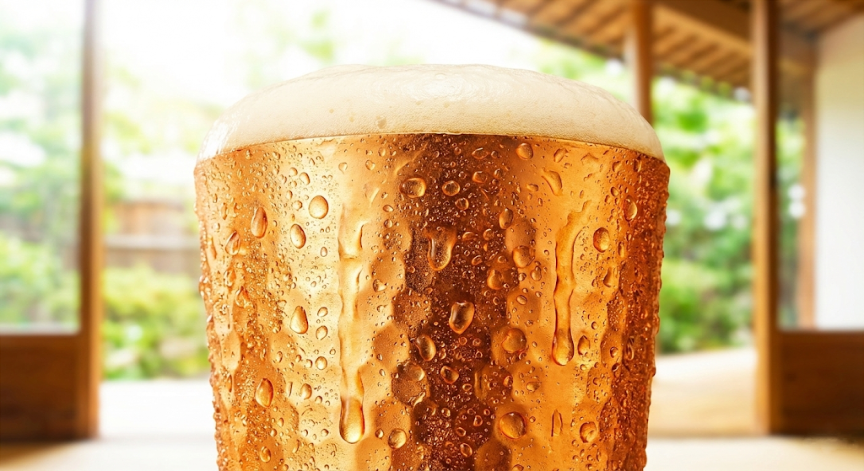 Copper tumbler covered in condensation, filled with cold beer