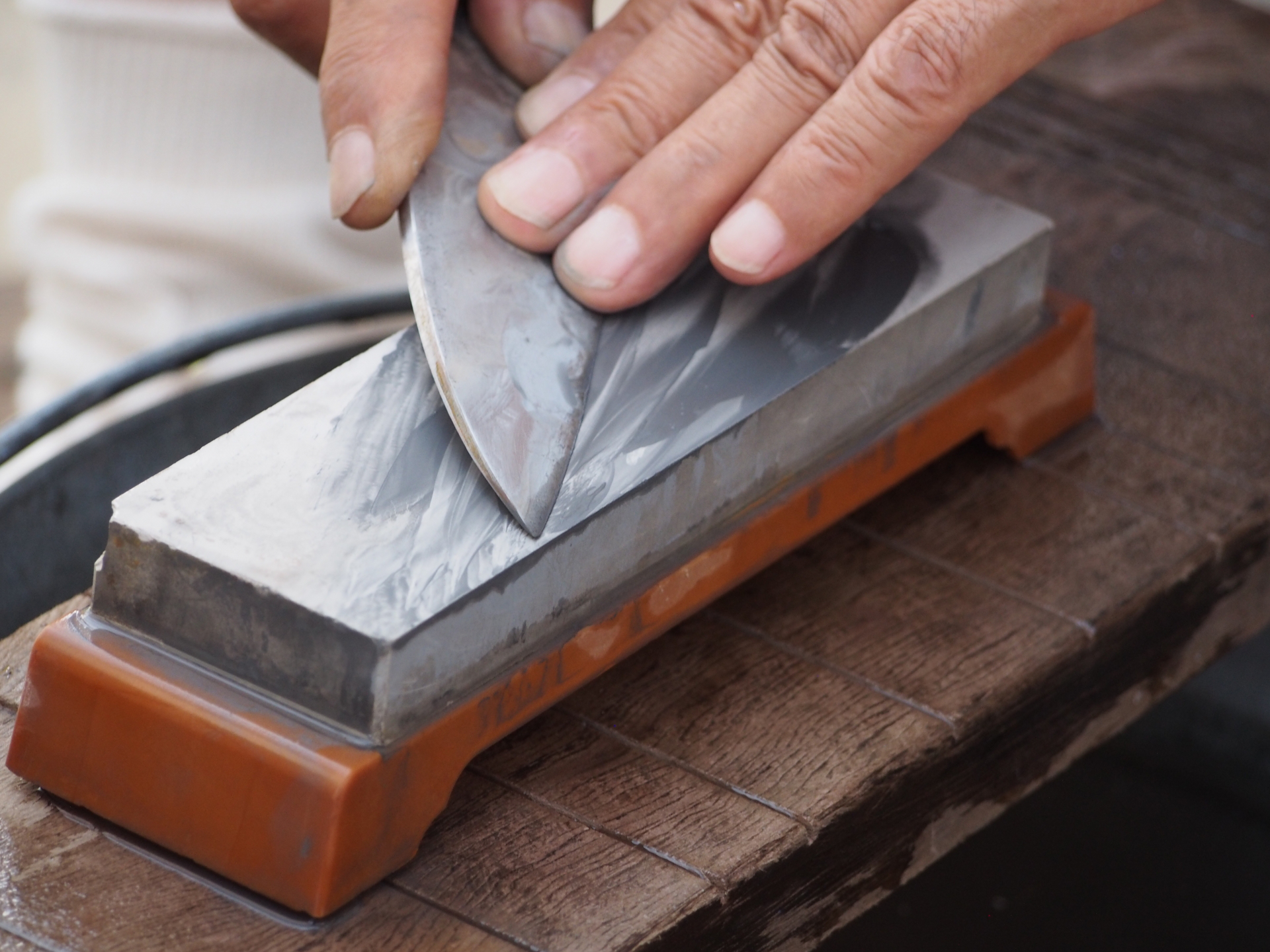 A Seki knife craftsman working on a Japanese kitchen knife, representing the city's blend of traditional skill and modern techniques
