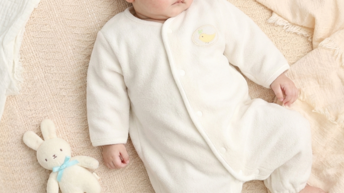 Baby sleeping soundly in a gauze sleeper