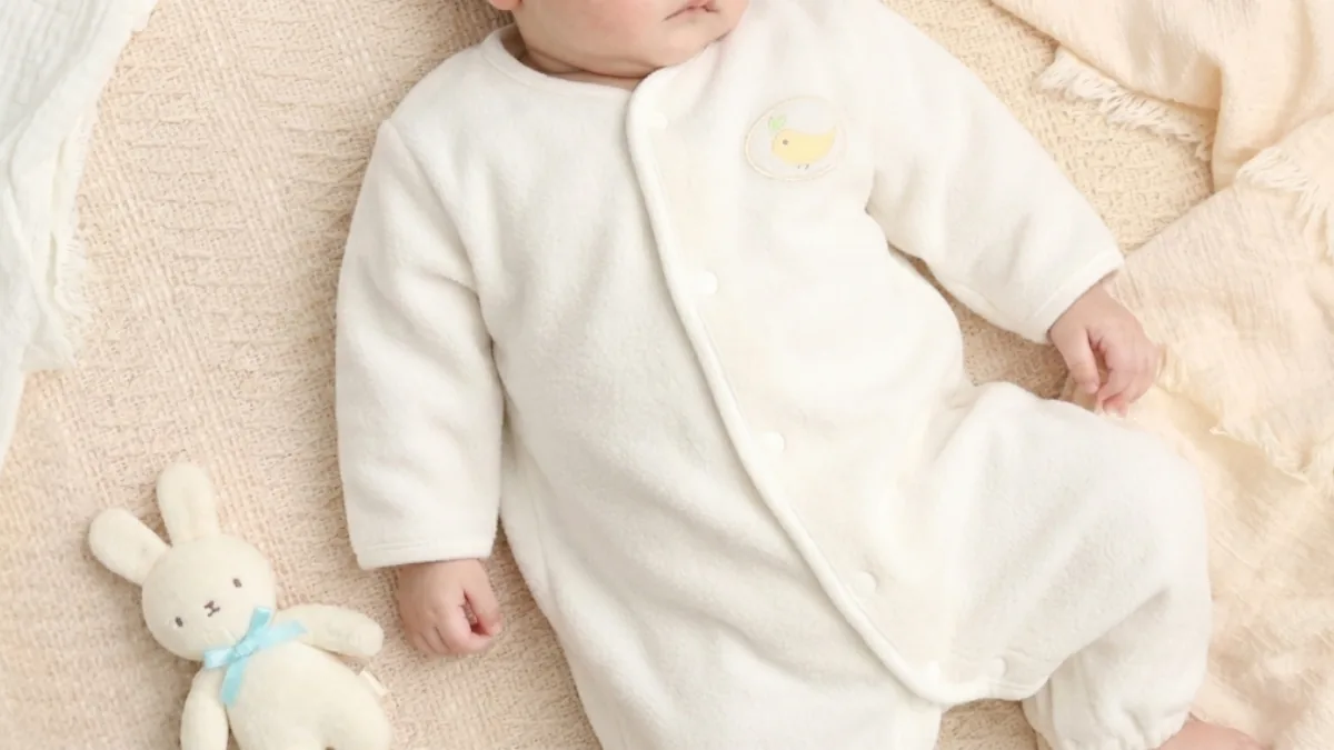 Baby sleeping soundly in a gauze sleeper
