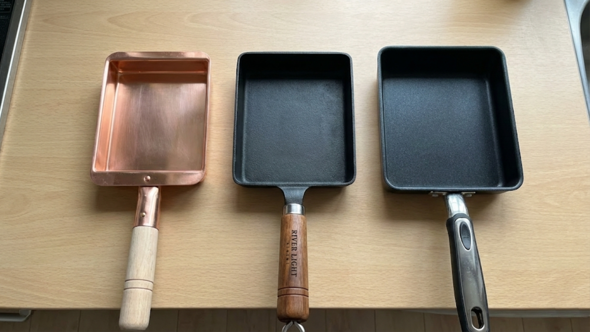 Side-by-side comparison of copper, iron, and coated aluminum Japanese tamagoyaki pans showing the different materials and finishes