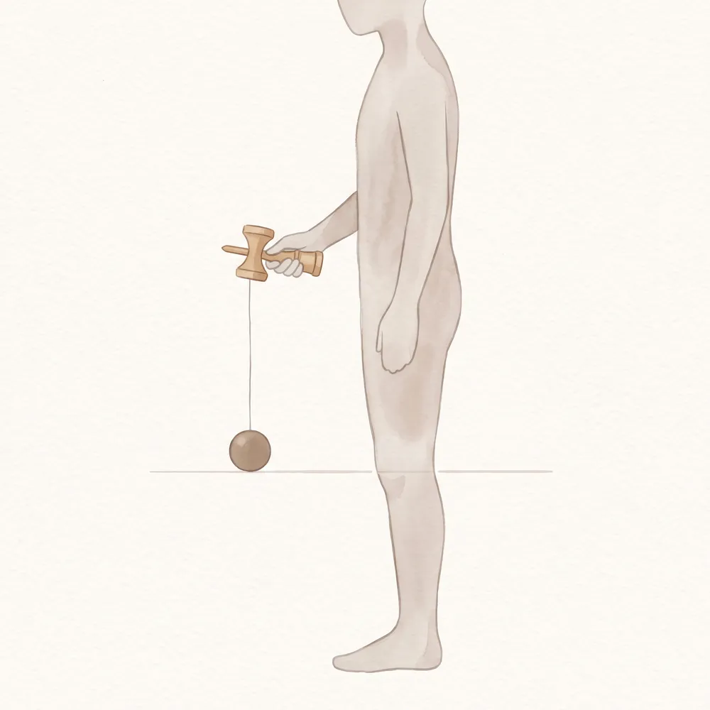 けんを持って腕を下ろしたとき、玉が膝の高さに来る糸の長さを示したイラスト