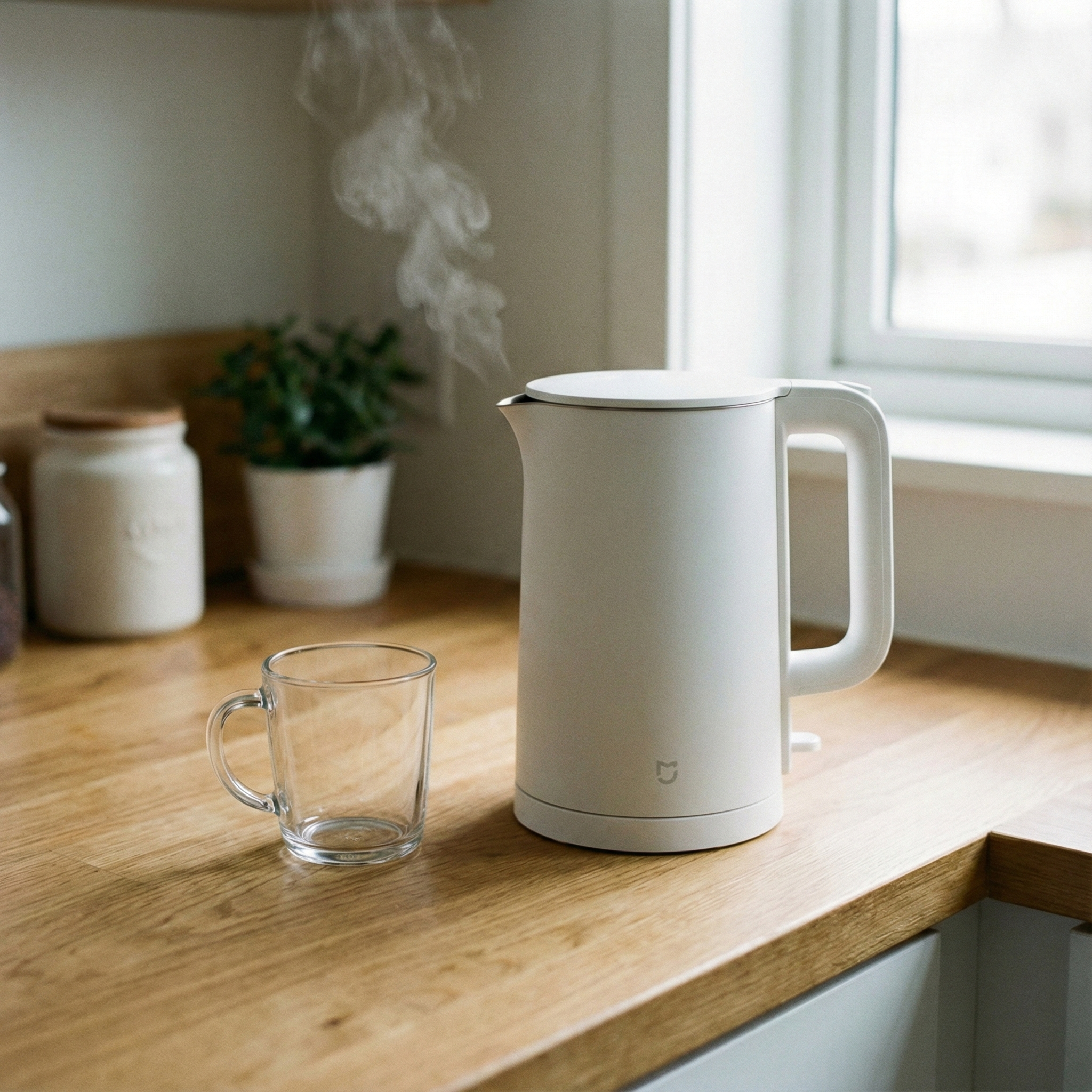 キッチンカウンターに置かれた電気ケトルとマグカップ